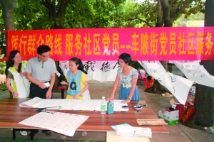 书法爱好者在党员活动日现场挥毫。 　　通讯员供图